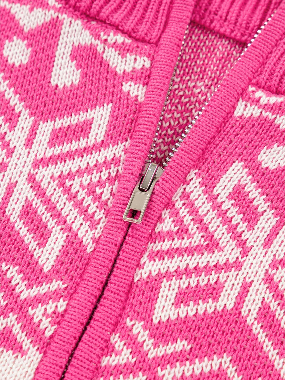 Pink and white Fair Isle knit quarter zip sweater with a silver zipper detail.