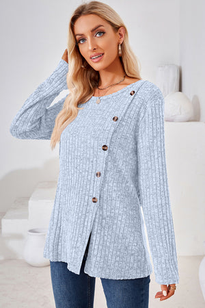 Light blue ribbed knit sweater with asymmetric button detail and crew neck.