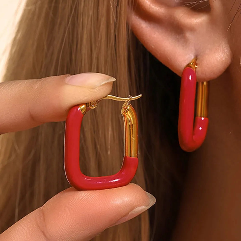 Red and gold two-tone enamel rectangle hoop earrings with a bold, chic design.