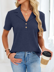 Navy waffle knit button placket polo shirt with a collared neckline and short sleeves.