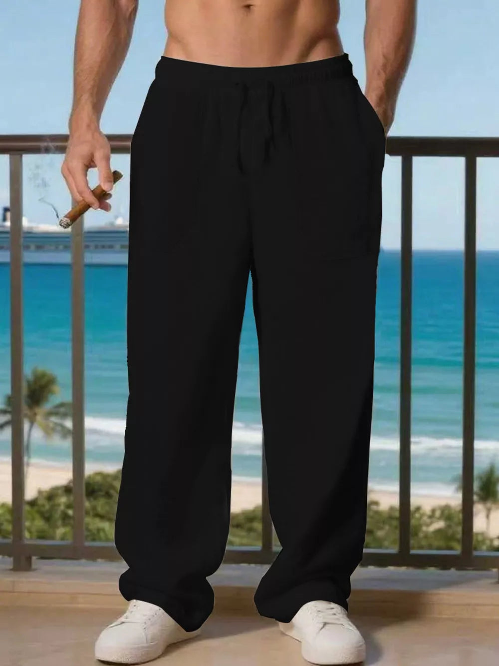 Men's black linen drawstring joggers with pockets, styled casually.