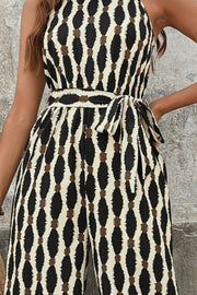 Geometric halter neck jumpsuit with tie waist and abstract pattern