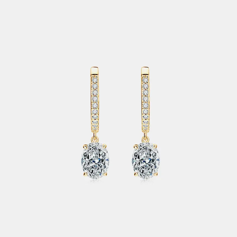 Gold pavé hoop and oval moissanite drop earrings with clear stones.