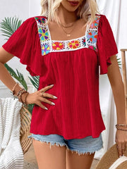 Red embroidered square neck flutter blouse with colorful floral detail on neckline.
