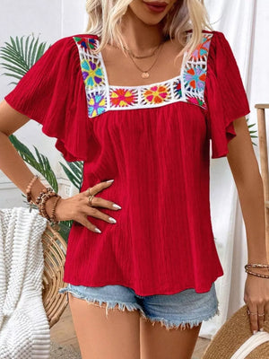 Red embroidered square neck flutter blouse with colorful floral detail on neckline.