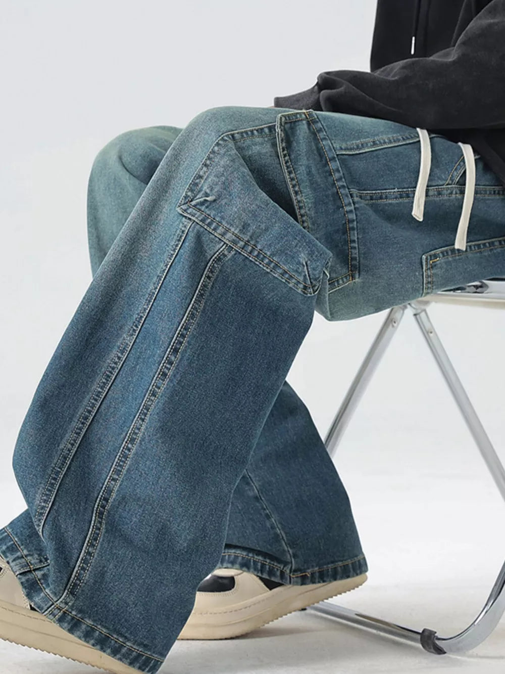 Light blue oversized cargo jeans with drawstring waist and large pockets.