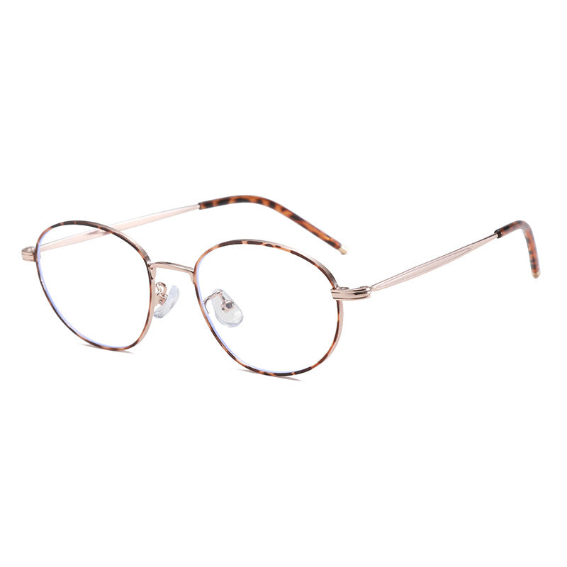 Vintage-inspired round frame eyeglasses with tortoise shell pattern temples and rose gold metal rims.