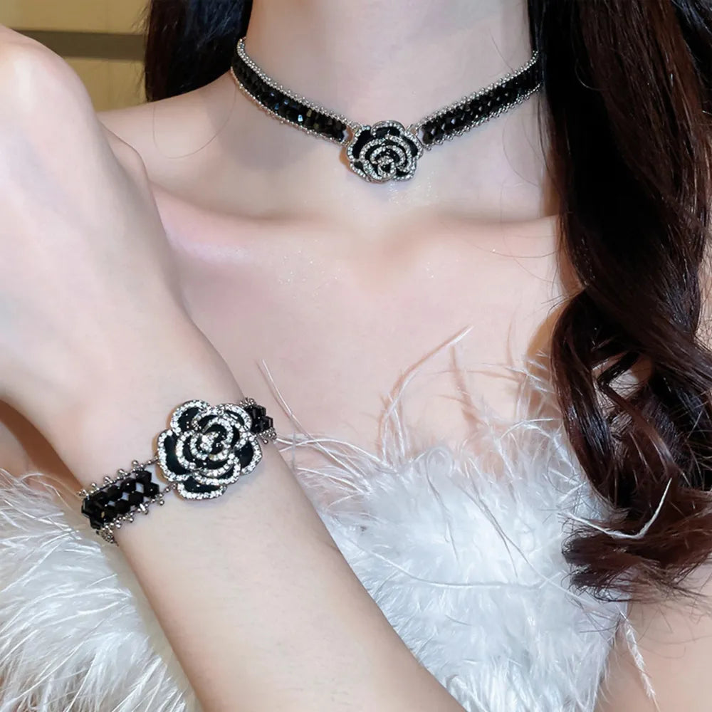 Black crystal rose choker necklace with matching bracelet, featuring sparkling details.