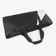 Modern color block travel bag in black with white accents and dual handles.