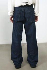 Dark wash denim wide-leg jeans with panel detail and distressed accents.