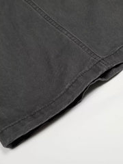 Grey relaxed fit cargo pants detail showing stitching and hem.