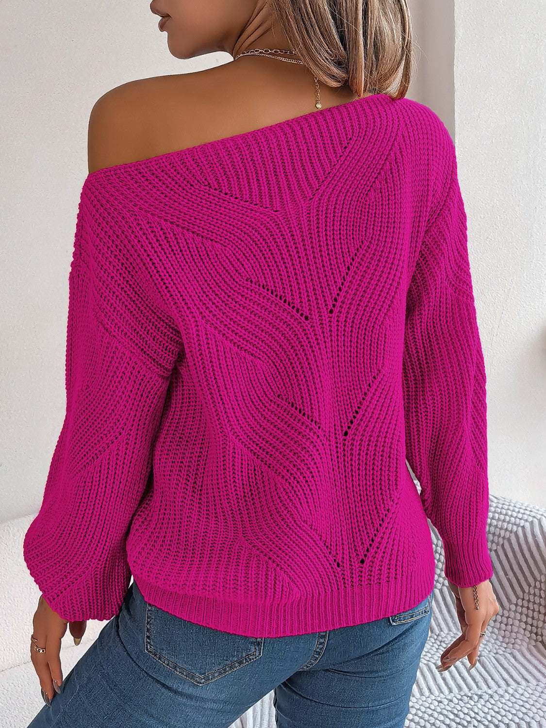 Off-the-shoulder knit sweater in Cerise with openwork detail and long sleeves.