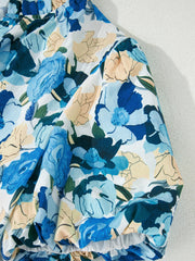 Cotton blouse with vibrant blue floral print and puff sleeves.