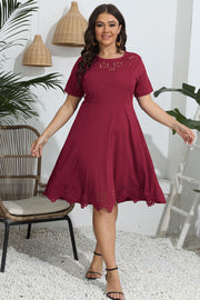Deep Red laser cutout flare midi dress with short sleeves and round neckline.