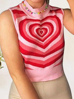 Pink knit tank top with bold red and pink heart intarsia pattern and mock neck.
