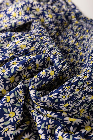 Daisy print smocked peplum blouse in dusty blue 100% viscose with smocked detail.
