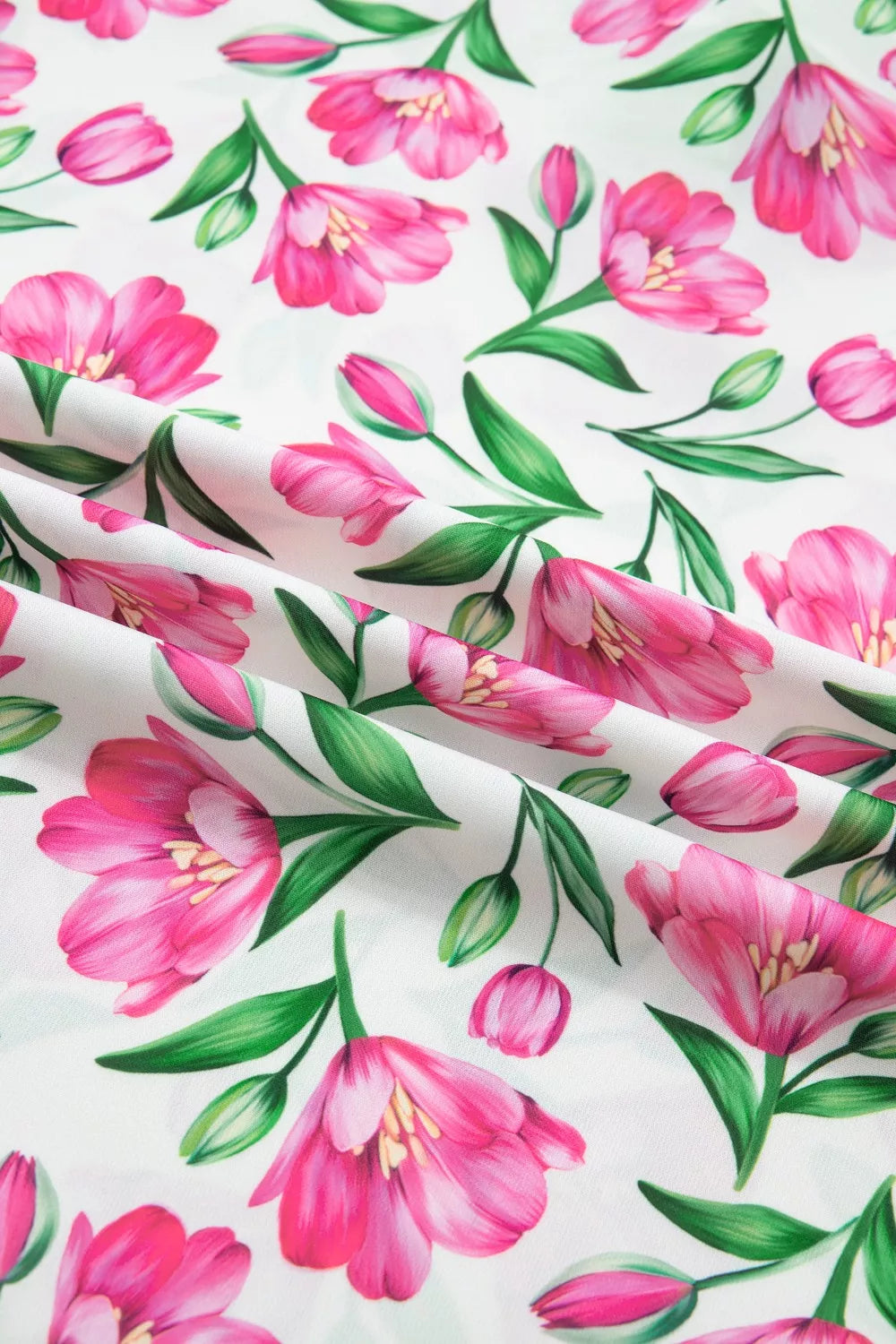 Tulip print polyester blouse with ruffled V-neck and frills.