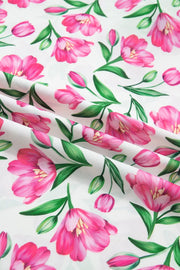 Tulip print polyester blouse with ruffled V-neck and frills.