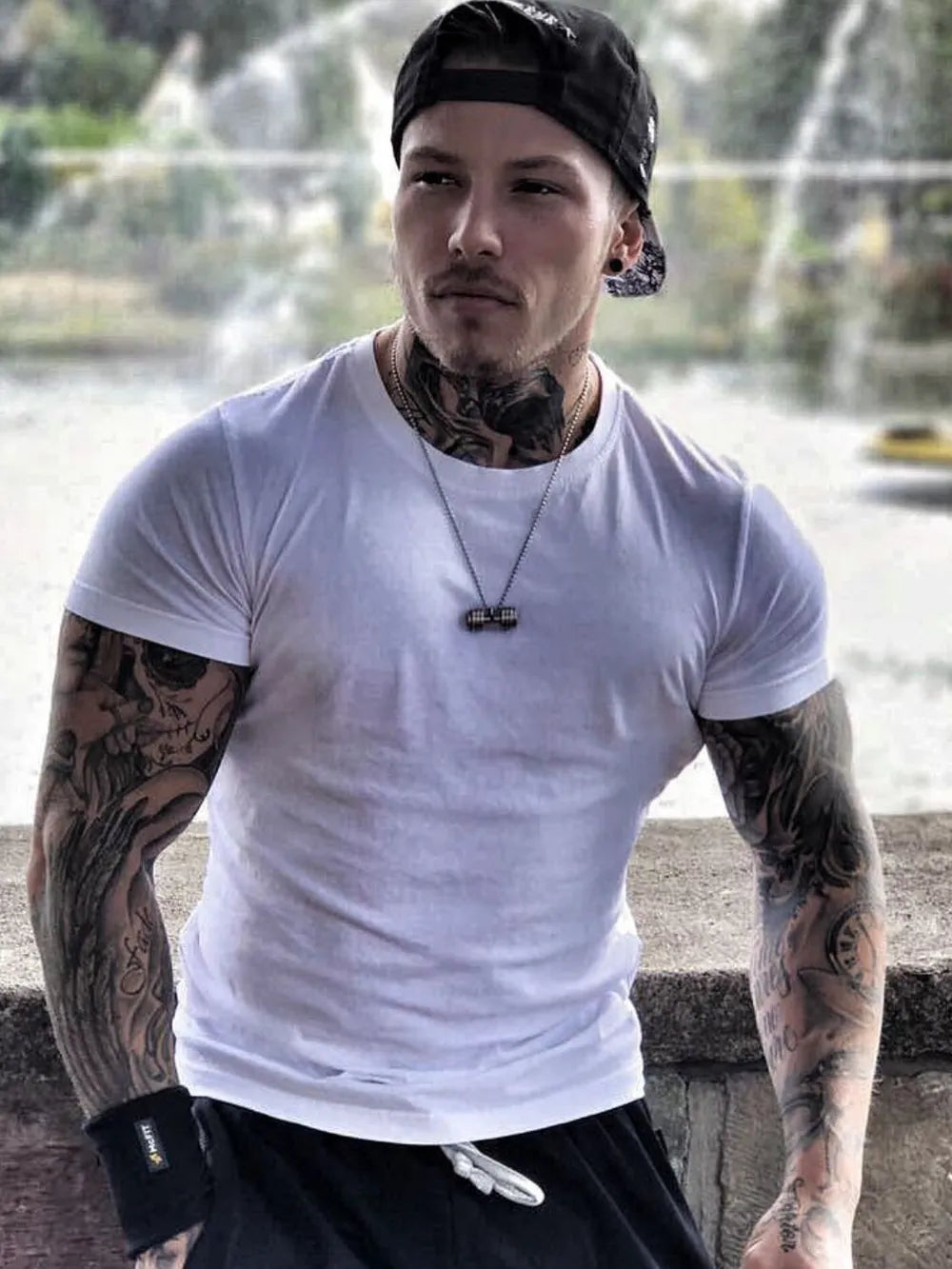 White crew neck t-shirt with short sleeves, a muscle fit, and a casual style.