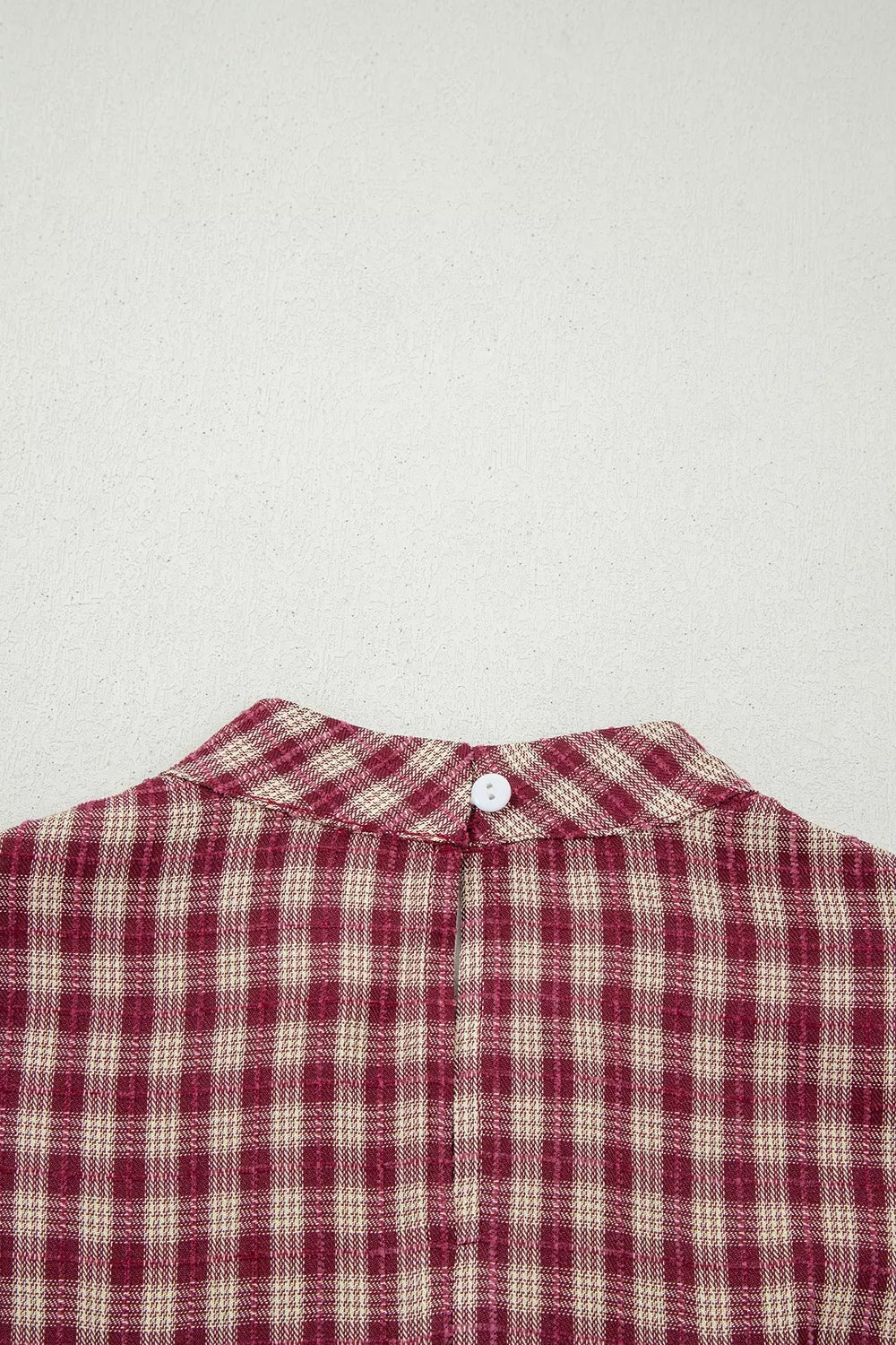 Burgundy plaid long sleeve blouse with button keyhole detail at back neck.