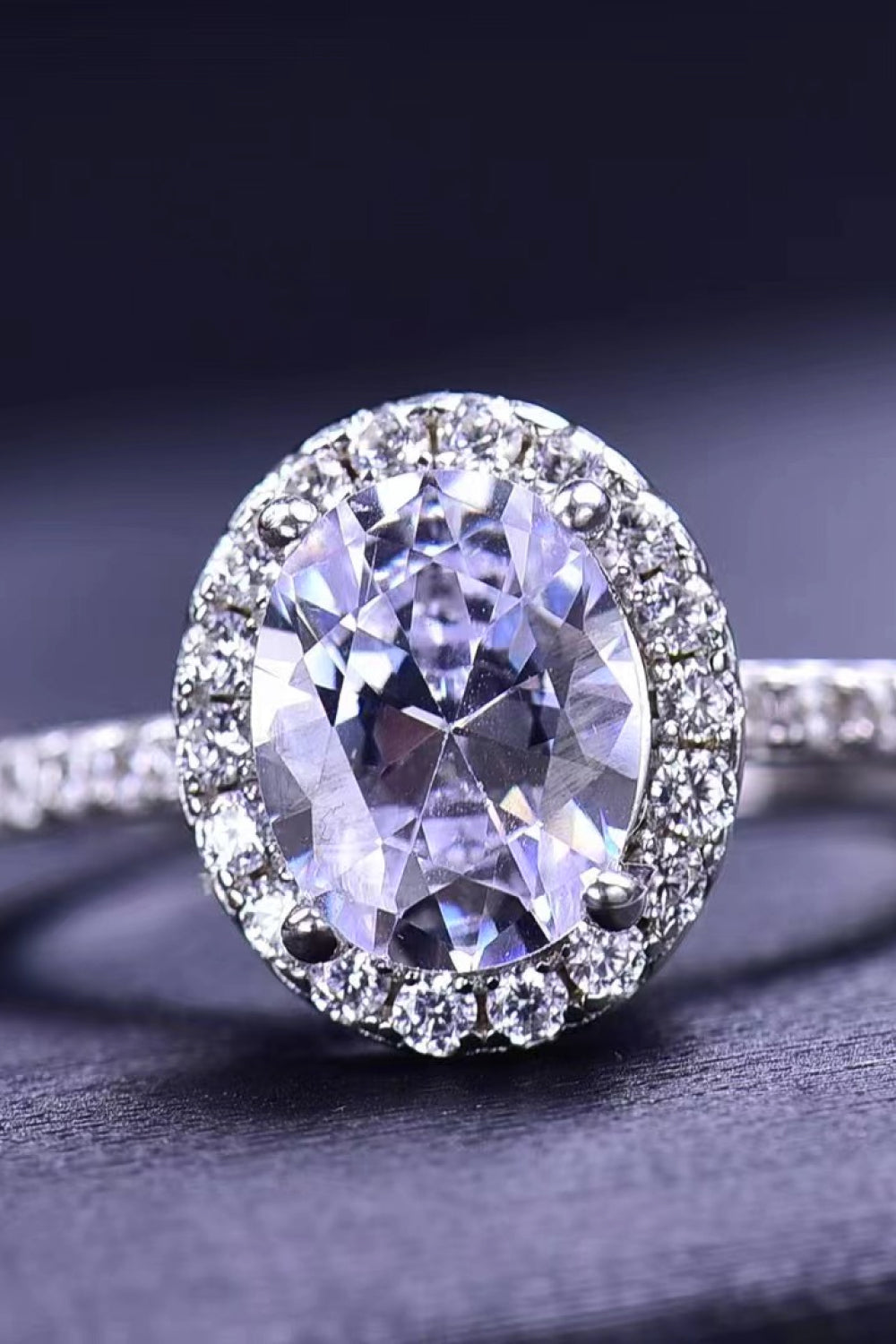 Halo oval diamond engagement ring in white gold with a sparkling halo setting.