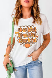 White graphic t-shirt with "thankful" in retro font, pie, pumpkin, and coffee cup graphics.