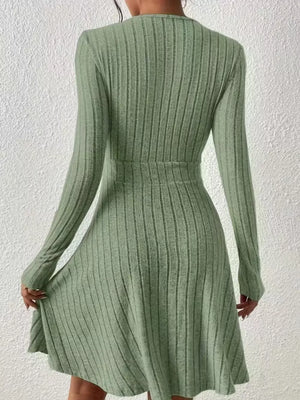 Sage green ribbed wrap mini dress with long sleeves and A-line skirt.