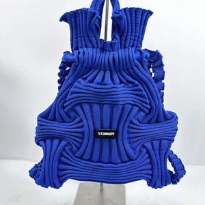 Royal blue textured knit medium backpack with ruched top and woven detail.