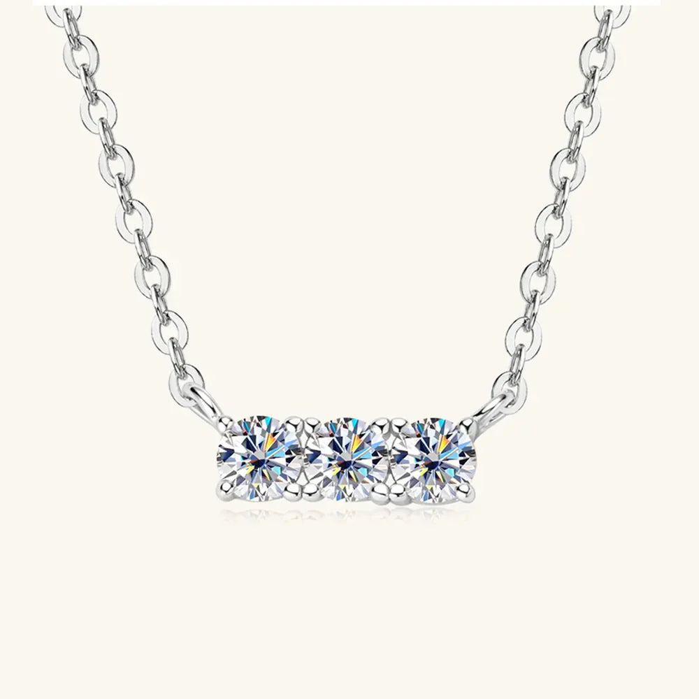 Silver bar necklace with three round moissanite stones on a delicate chain.