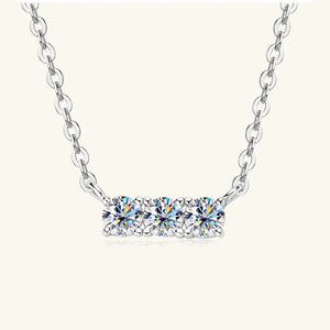 Silver bar necklace with three round moissanite stones on a delicate chain.