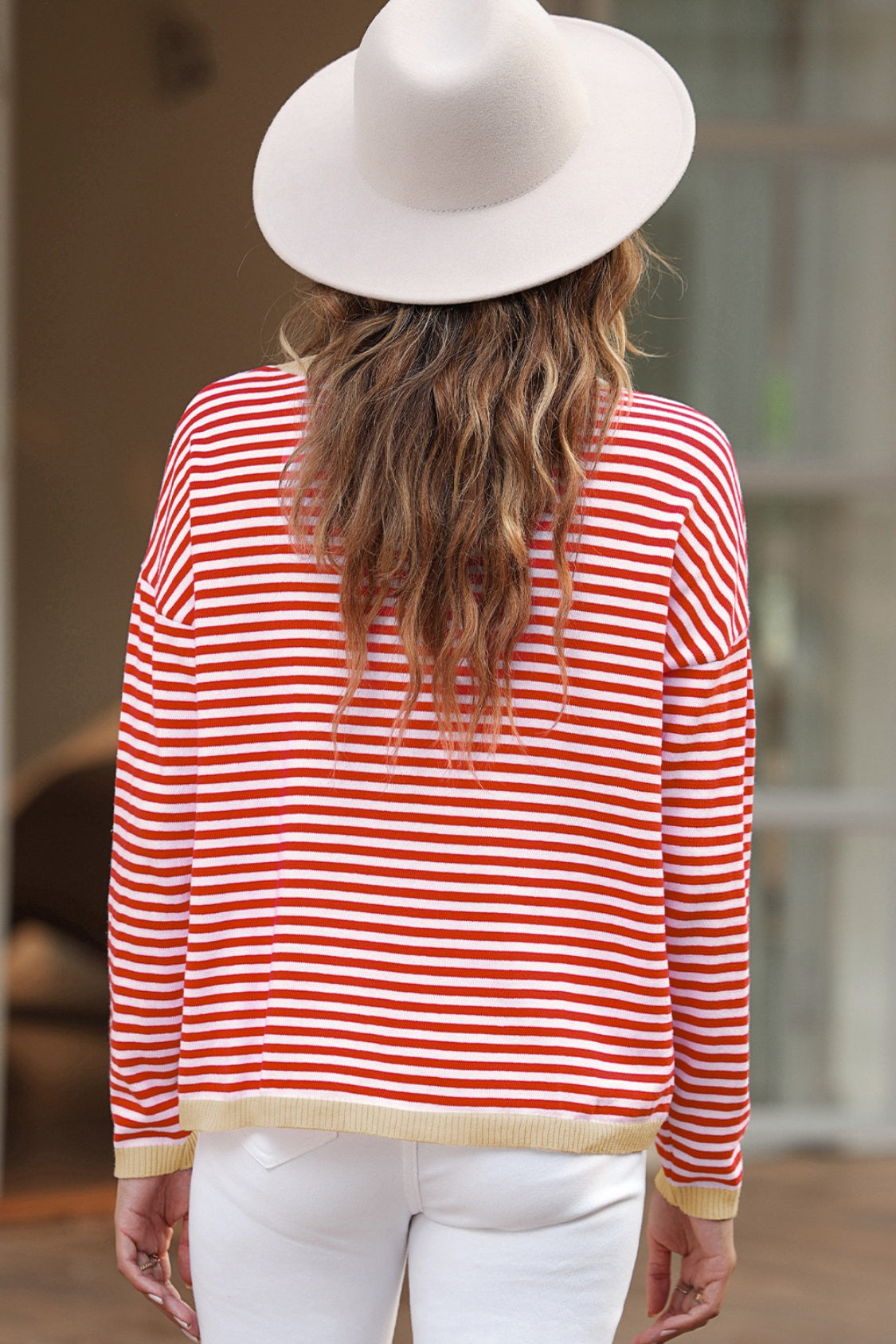 Nautical knit crewneck sweater with red and white stripes and contrast trim hem.