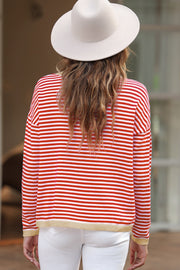 Nautical knit crewneck sweater with red and white stripes and contrast trim hem.