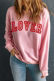 Blush pink sweatshirt with red "LOVER" graphic, drop shoulder, and crew neck.