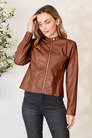 Biker jacket in Dark Camel faux leather with a mock neck and silver zipper detail.