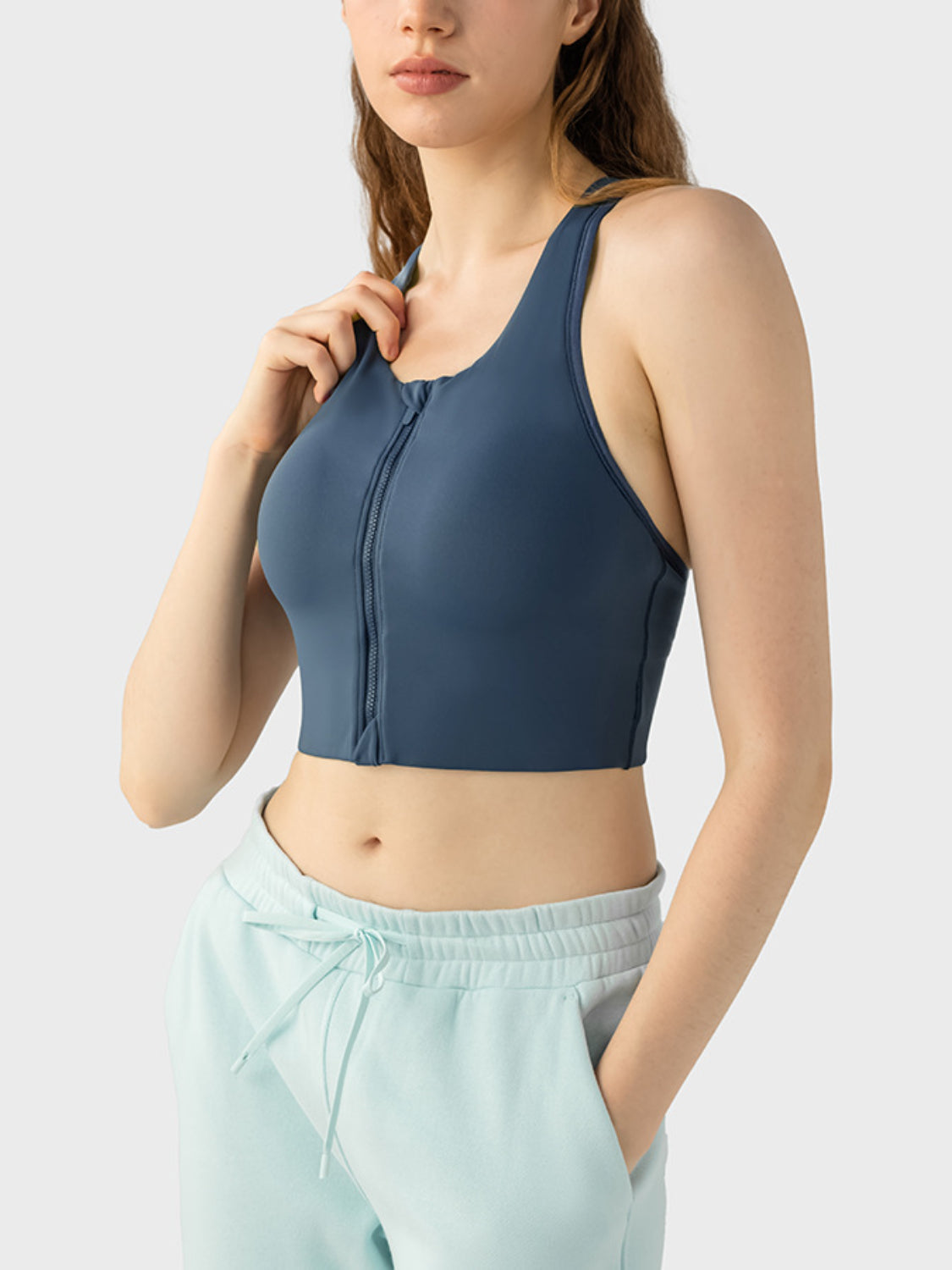 Zip-front racerback sports bra in dark blue with a cropped fit.