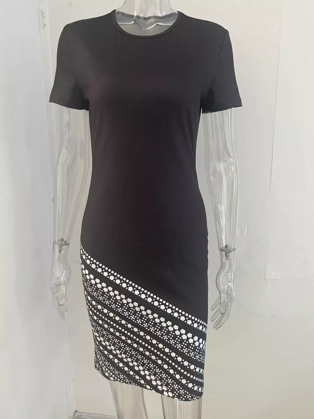 Black bodycon mini dress with geometric print detail on the hem