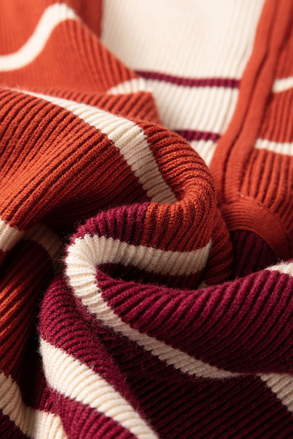 Colorblock ribbed mini dress in terracotta, cream, and burgundy stripes.