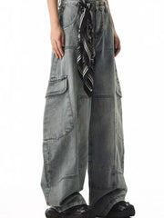 Relaxed fit light wash denim cargo jeans with spacious pockets and a bandana tied at the waist.