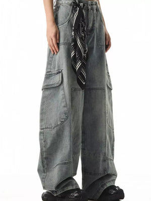Relaxed fit light wash denim cargo jeans with spacious pockets and a bandana tied at the waist.