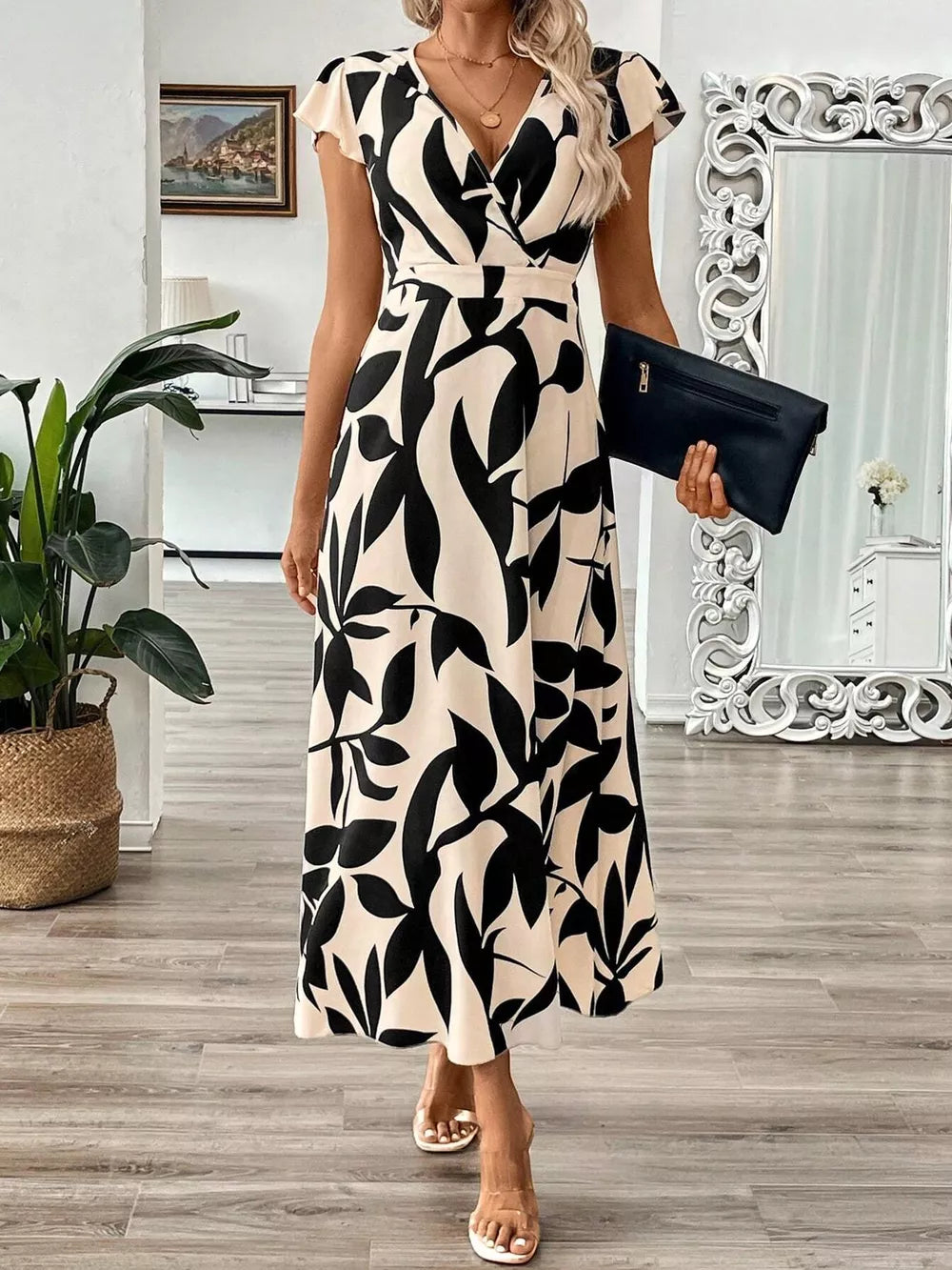 Floral print midi dress with cap sleeves and a V-neck in black and apricot abstract pattern.