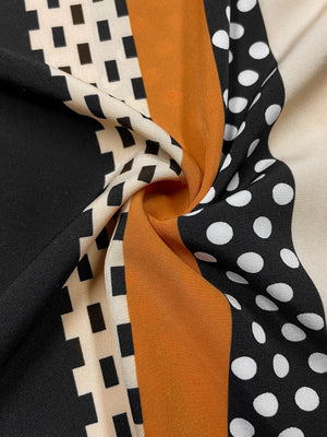 Black blouse with asymmetric stripe and polka dot pattern