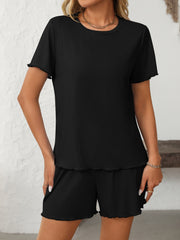 Black ribbed lounge set with raw edge trim on t-shirt and shorts.