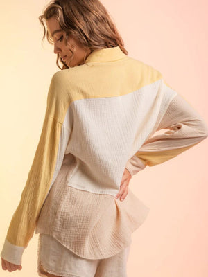 Colorblock gauze shirt jacket in yellow, cream, and tan with a relaxed fit and buttoned collar.