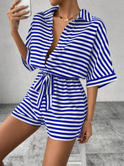 Royal blue and white striped shirt romper with button front and self-tie belt.