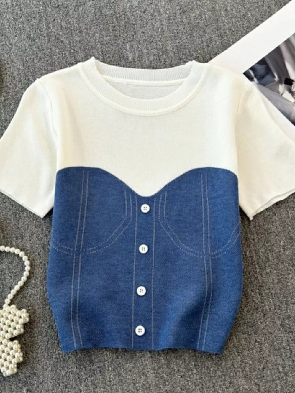 Color block knit t-shirt in white and blue with ribbed detail and button front.