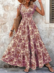 Maxi dress with smocked bodice, v-neck, short sleeves, and tiered skirt in a damask print.