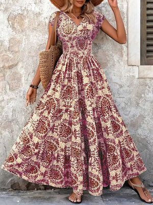 Maxi dress with smocked bodice, v-neck, short sleeves, and tiered skirt in a damask print.