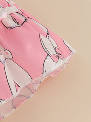 Pink baby dress with bunny print and ruffled trim, matching headband shown.