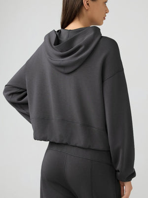 Cropped active hoodie in dark gray with raglan sleeves and a relaxed fit.