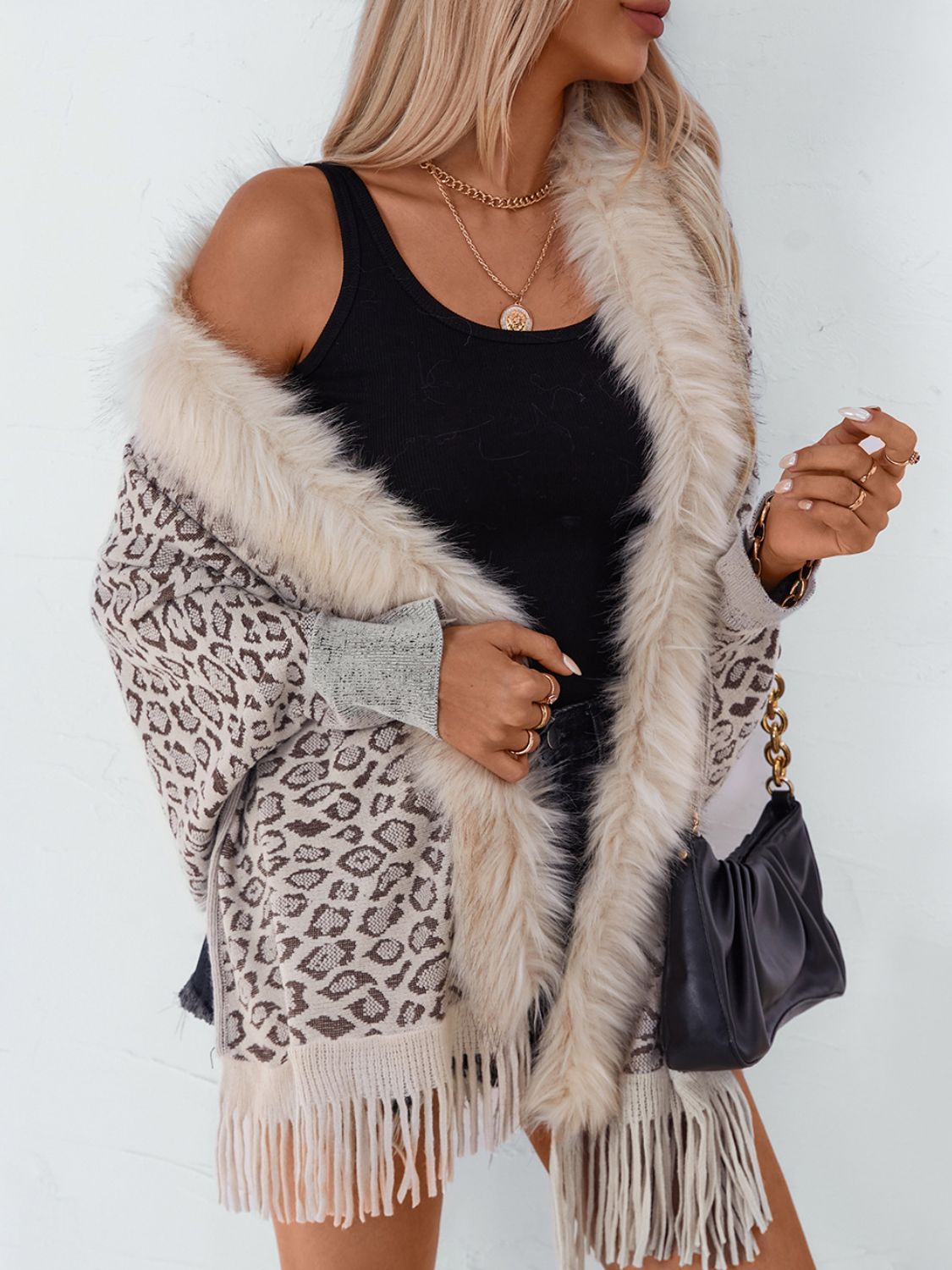 Leopard print cardigan with faux fur trim and fringe hem, in beige and brown tones.